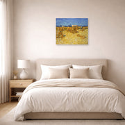 Unframed poster print of Vincent van Gogh's Harvest in Provence displayed on a wall in a bedroom