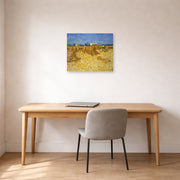 Unframed poster print of Vincent van Gogh's Harvest in Provence displayed on a wall in a home office