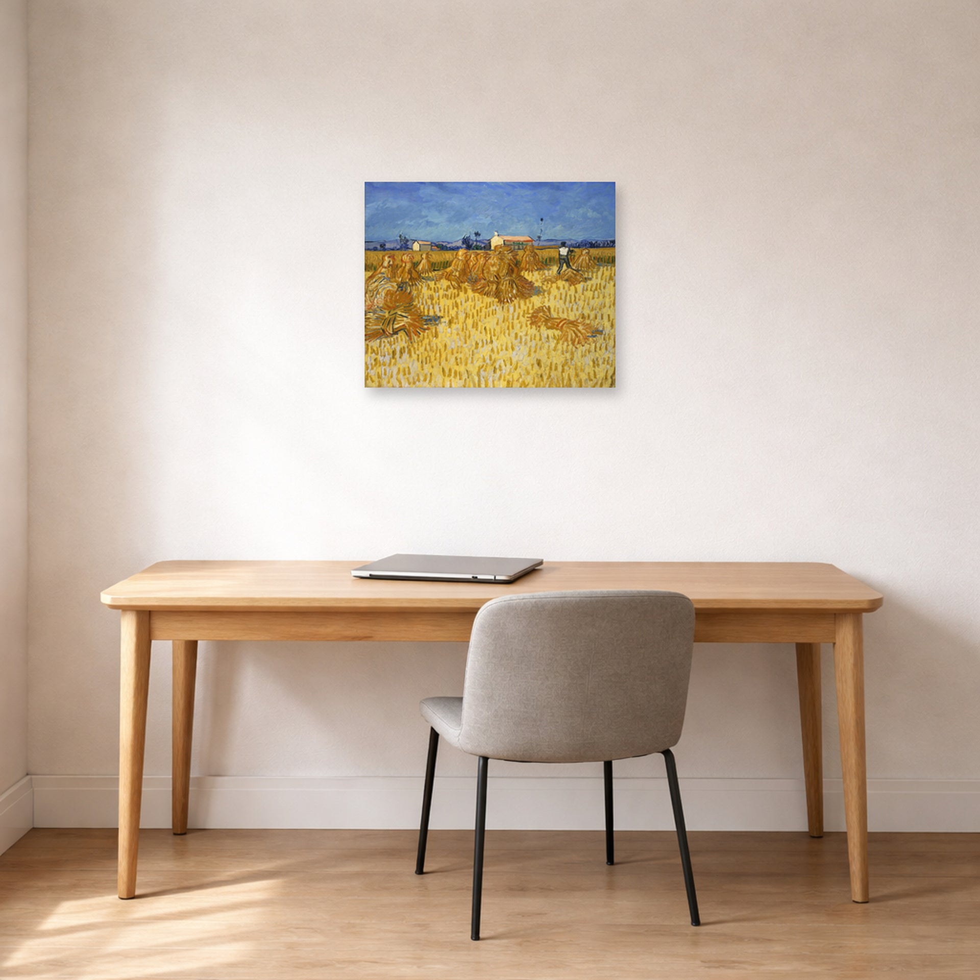 Unframed poster print of Vincent van Gogh's Harvest in Provence displayed on a wall in a home office
