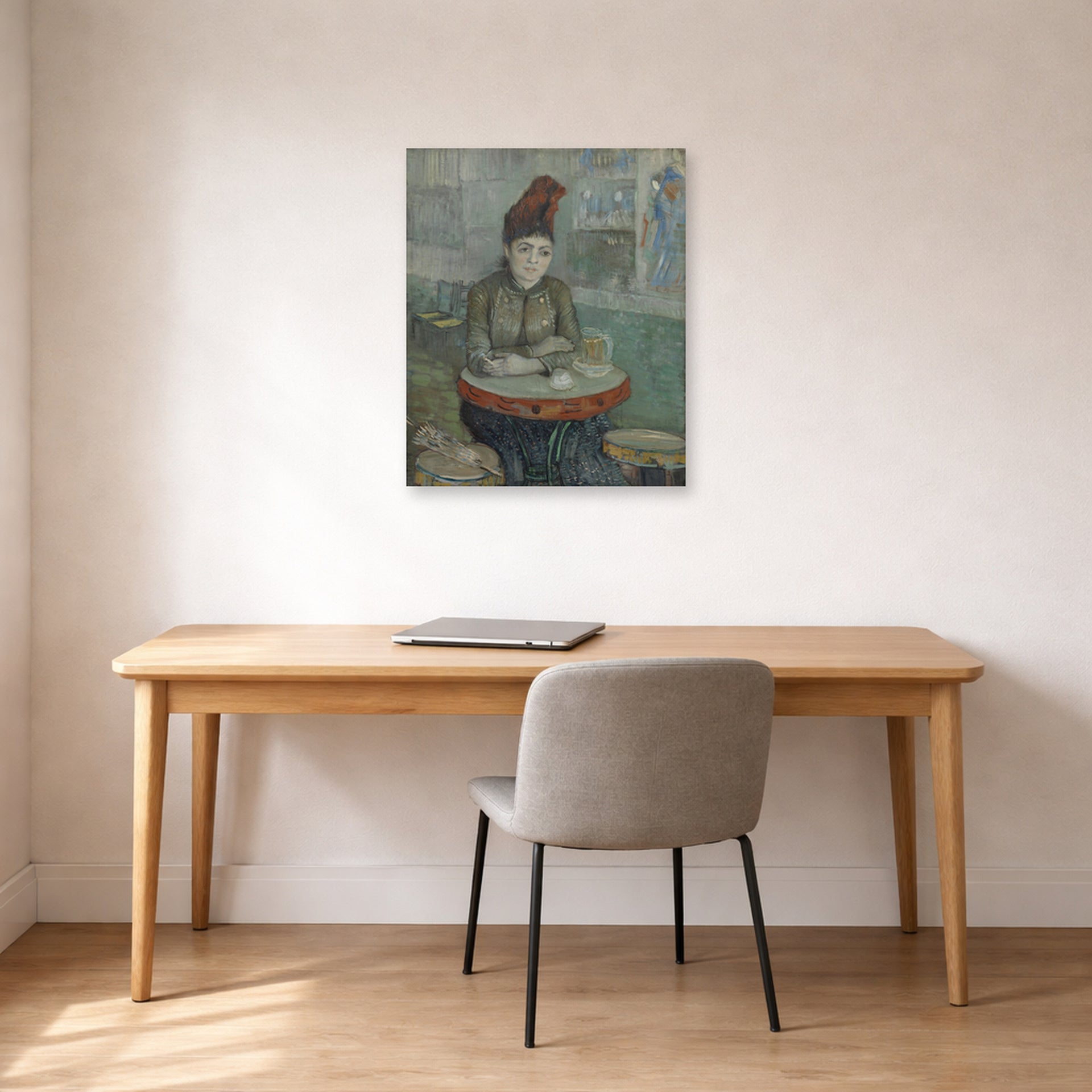 Unframed poster print of Vincent van Gogh's In the Cafe displayed on a wall in a home office