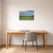 Gallery-wrapped canvas print of Vincent van Gogh's Landscape Under a Stormy Sky displayed on a wall in a home office