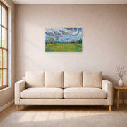 Unframed poster print of Vincent van Gogh's Landscape Under a Stormy Sky displayed on a wall in a living room