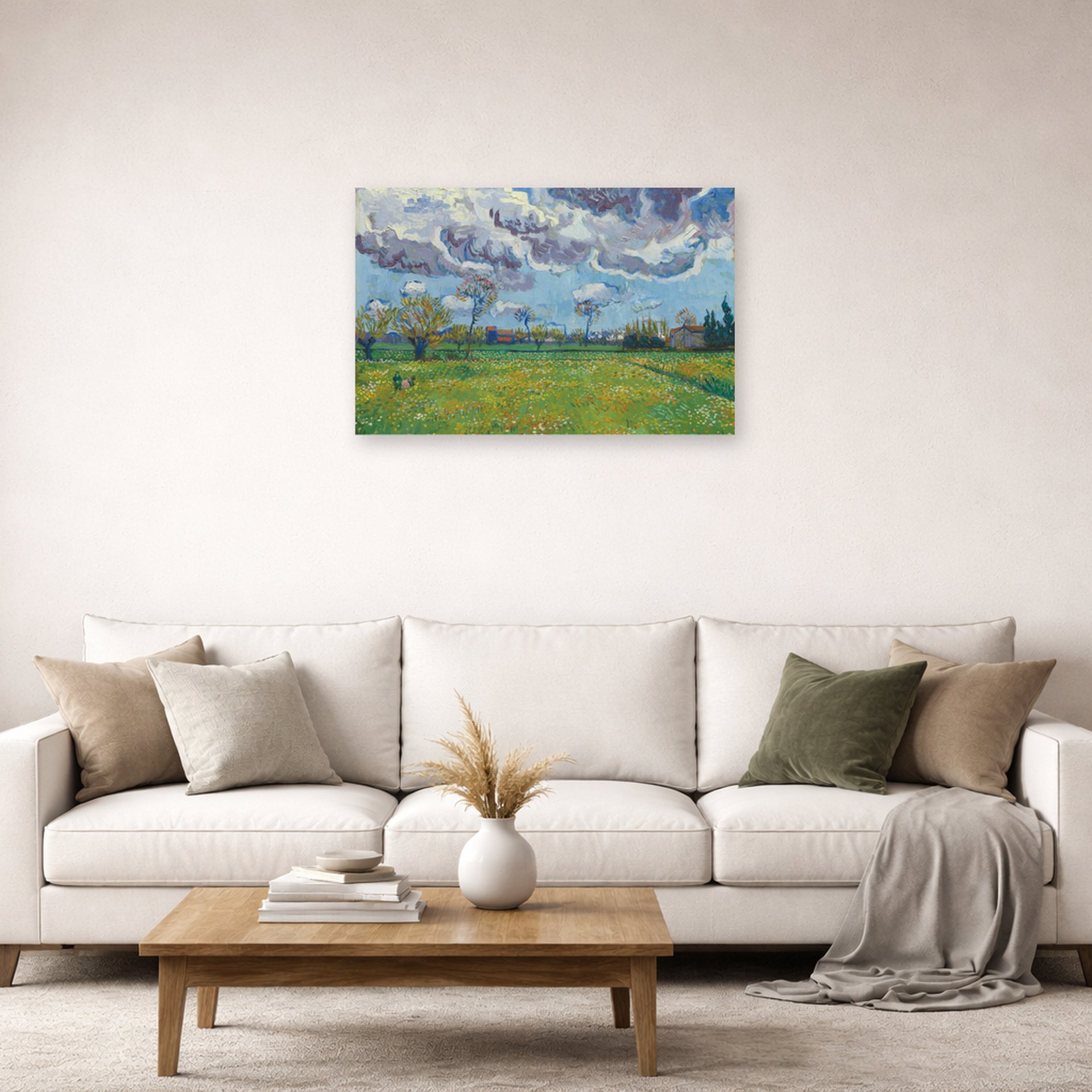 Unframed poster print of Vincent van Gogh's Landscape Under a Stormy Sky displayed on a wall in a living room