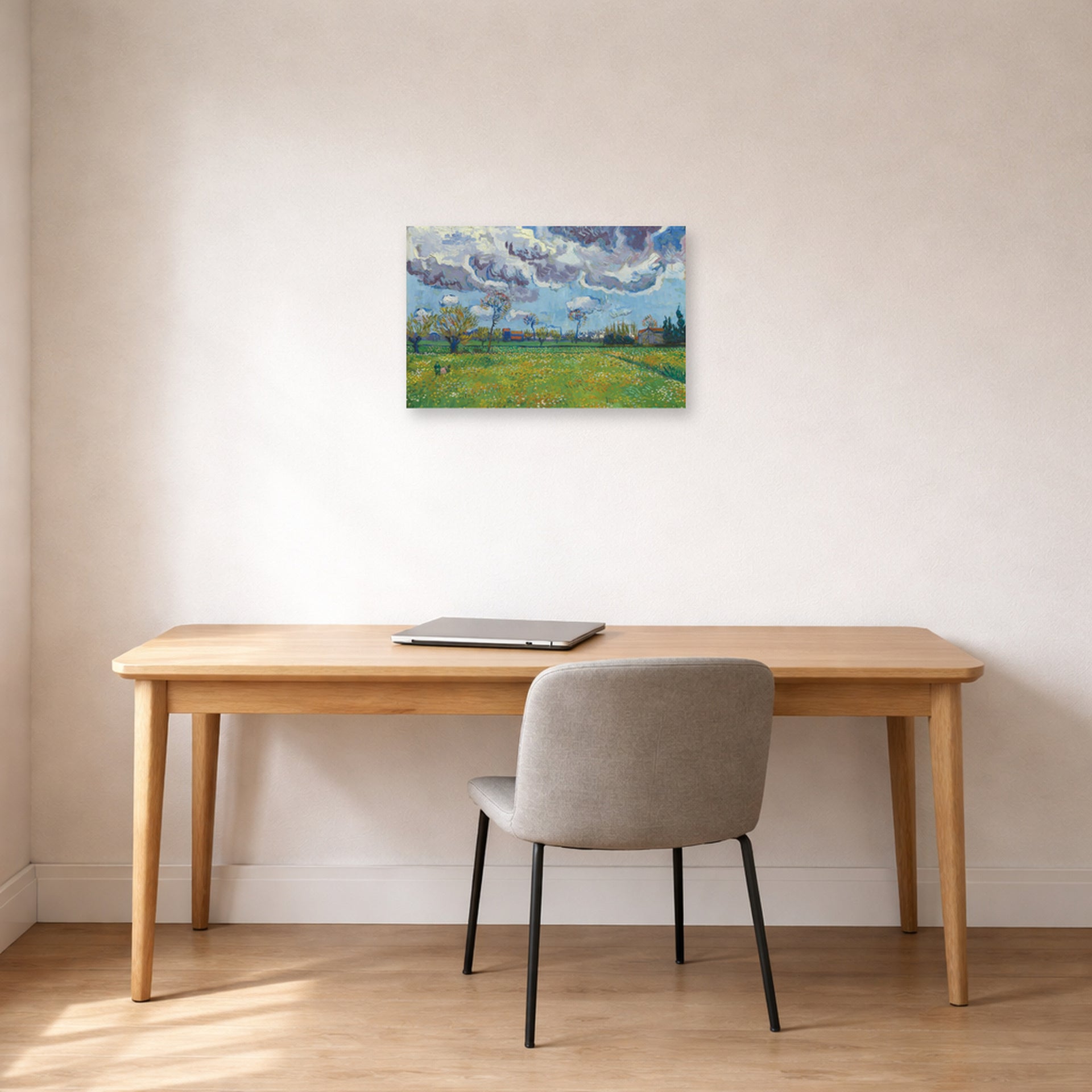 Unframed poster print of Vincent van Gogh's Landscape Under a Stormy Sky displayed on a wall in a home office