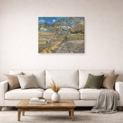 Gallery-wrapped canvas print of Vincent van Gogh's Landscape at Saint Rimy displayed on a wall in a living room