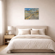 Unframed poster print of Vincent van Gogh's Landscape at Saint Rimy displayed on a wall in a bedroom