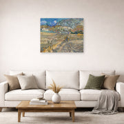 Unframed poster print of Vincent van Gogh's Landscape at Saint Rimy displayed on a wall in a living room