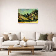 Unframed poster print of Vincent van Gogh's Mountains at Saint Remy with Dark Cottage displayed on a wall in a living room
