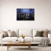 Unframed poster print of Vincent van Gogh's Night over the Rhone displayed on a wall in a living room