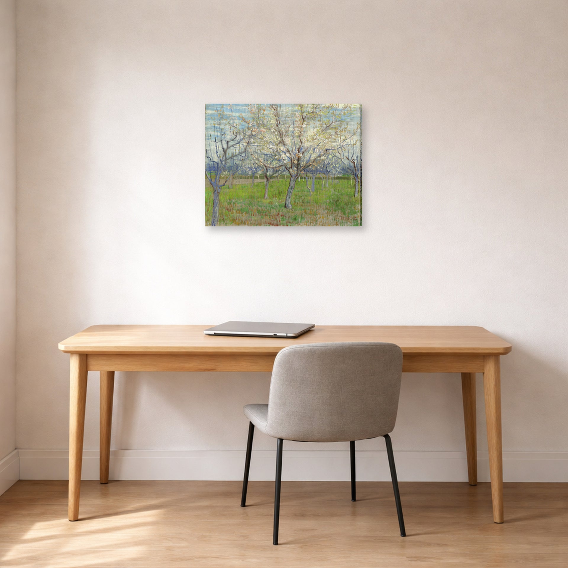 Gallery-wrapped canvas print of Vincent van Gogh's Orchard with Blossoming Apricot Trees displayed on a wall in a home office