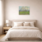 Unframed poster print of Vincent van Gogh's Orchard with Blossoming Apricot Trees displayed on a wall in a bedroom