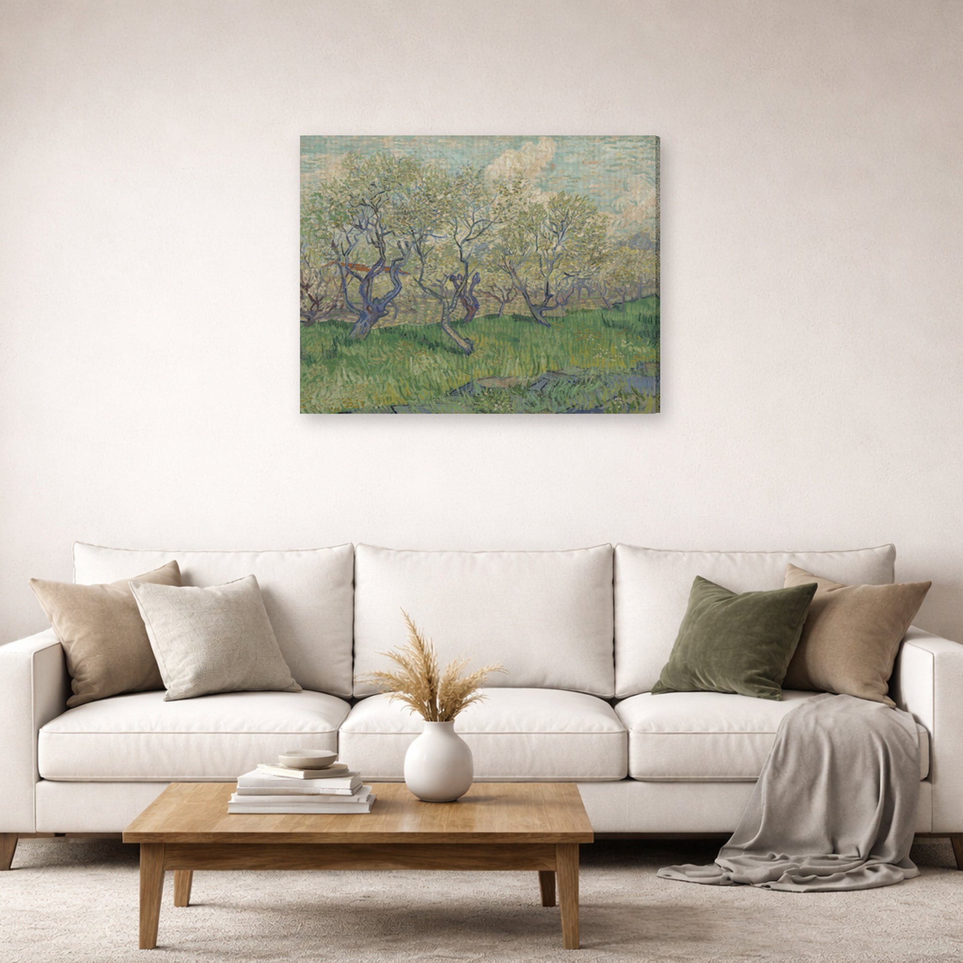 Gallery-wrapped canvas print of Vincent van Gogh's Orchard in Blossom displayed on a wall in a living room