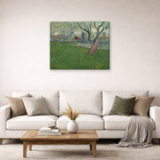 Gallery-wrapped canvas print of Vincent van Gogh's Orchards in Blossom, View of Arles displayed on a wall in a living room