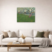 Unframed poster print of Vincent van Gogh's Orchards in Blossom, View of Arles displayed on a wall in a living room