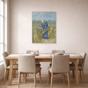 Unframed poster print of Vincent van Gogh's Peasant Woman Binding Sheaves displayed on a wall in a dining room