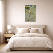 Unframed poster print of Vincent van Gogh's Small Pear Tree in Blossom displayed on a wall in a bedroom
