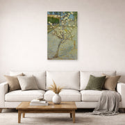 Unframed poster print of Vincent van Gogh's Small Pear Tree in Blossom displayed on a wall in a living room