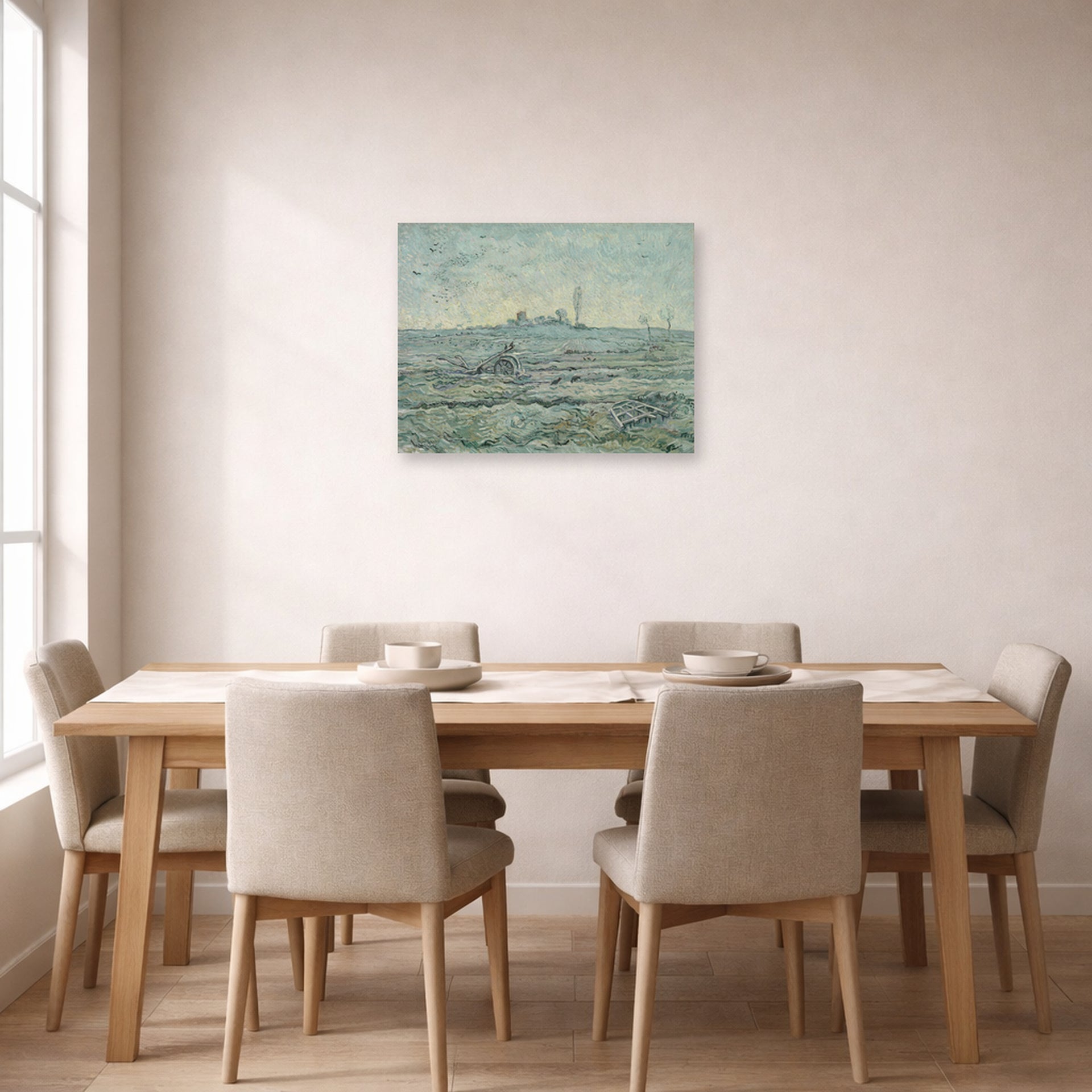 Unframed poster print of Vincent van Gogh's Snow Covered Field with a Harrow (after Millet) displayed on a wall in a dining room