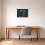 Unframed poster print of Vincent van Gogh's Starry Night displayed on a wall in a home office