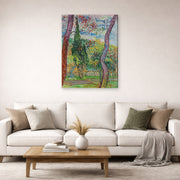 Gallery-wrapped canvas print of Vincent van Gogh's The Garden of Saint Paul Hospital displayed on a wall in a living room