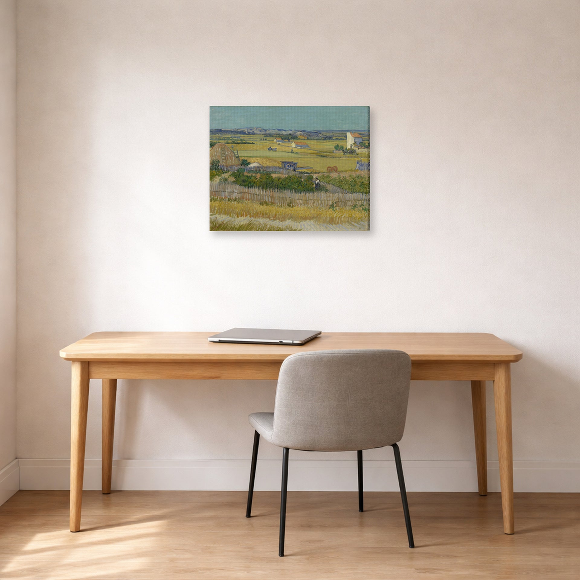 Gallery-wrapped canvas print of Vincent van Gogh's The Harvest displayed on a wall in a home office