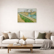 Unframed poster print of Vincent van Gogh's The Langlois Bridge displayed on a wall in a living room