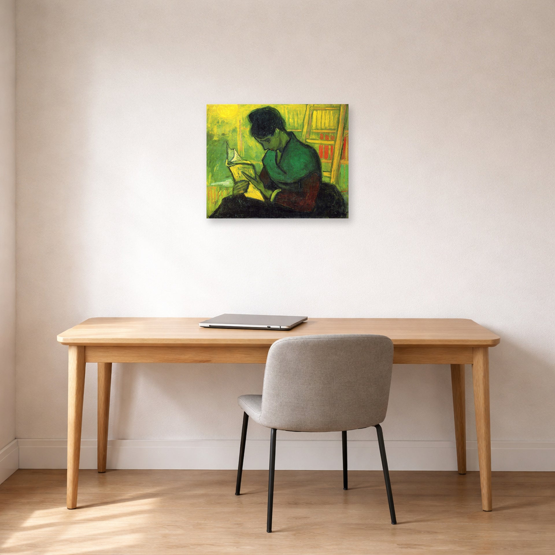Unframed poster print of Vincent van Gogh's The Novel Reader displayed on a wall in a home office