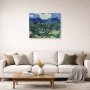 Unframed poster print of Vincent van Gogh's The Olive Trees displayed on a wall in a living room