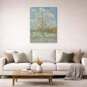 Gallery-wrapped canvas print of Vincent van Gogh's The Pink Peach Tree displayed on a wall in a living room