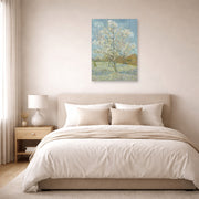 Unframed poster print of Vincent van Gogh's The Pink Peach Tree displayed on a wall in a bedroom