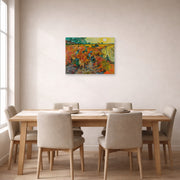 Unframed poster print of Vincent van Gogh's The Red Vineyards at Arles displayed on a wall in a dining room