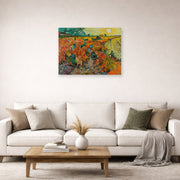 Unframed poster print of Vincent van Gogh's The Red Vineyards at Arles displayed on a wall in a living room