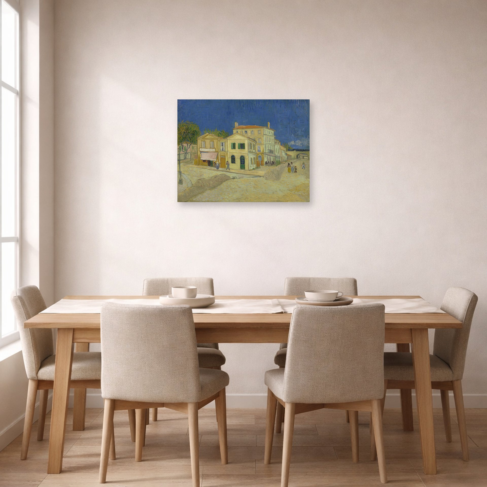 Unframed poster print of Vincent van Gogh's The Yellow House (the Street) displayed on a wall in a dining room