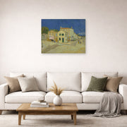 Unframed poster print of Vincent van Gogh's The Yellow House (the Street) displayed on a wall in a living room
