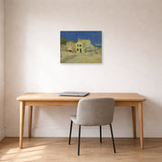 Unframed poster print of Vincent van Gogh's The Yellow House (the Street) displayed on a wall in a home office