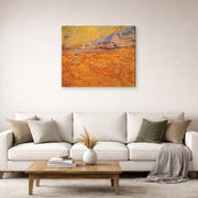 Gallery-wrapped canvas print of Vincent van Gogh's Wheat Fields with Reaper at Sunrise displayed on a wall in a living room
