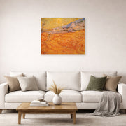 Unframed poster print of Vincent van Gogh's Wheat Fields with Reaper at Sunrise displayed on a wall in a living room