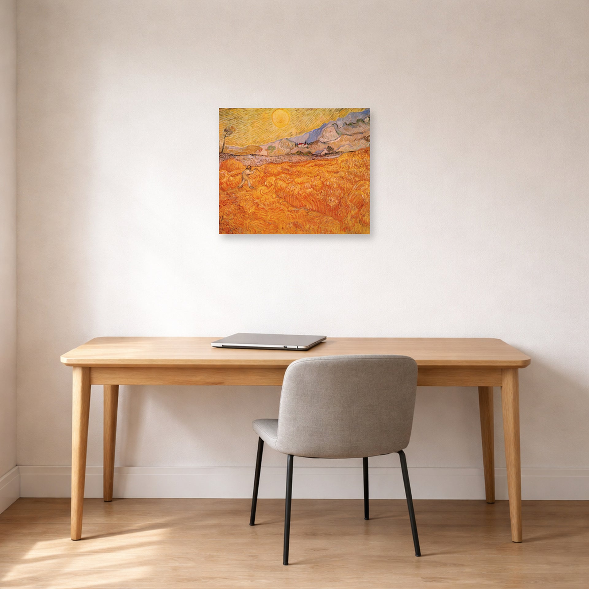 Unframed poster print of Vincent van Gogh's Wheat Fields with Reaper at Sunrise displayed on a wall in a home office