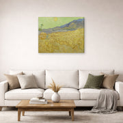 Gallery-wrapped canvas print of Vincent van Gogh's Wheatfield with a Reaper displayed on a wall in a living room
