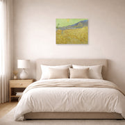 Unframed poster print of Vincent van Gogh's Wheatfield with a Reaper displayed on a wall in a bedroom