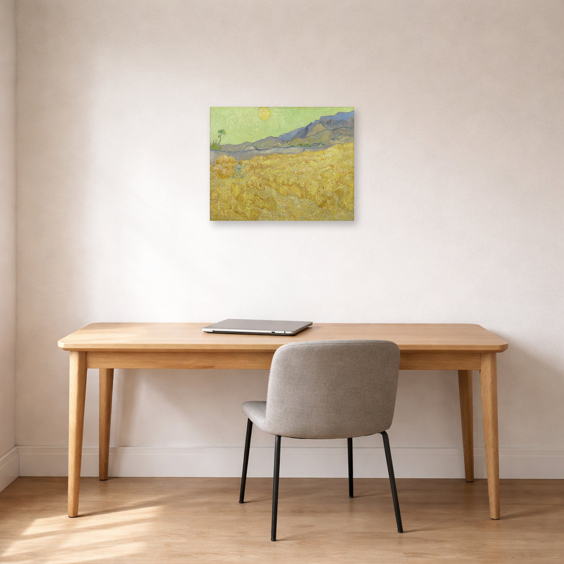Unframed poster print of Vincent van Gogh's Wheatfield with a Reaper displayed on a wall in a home office