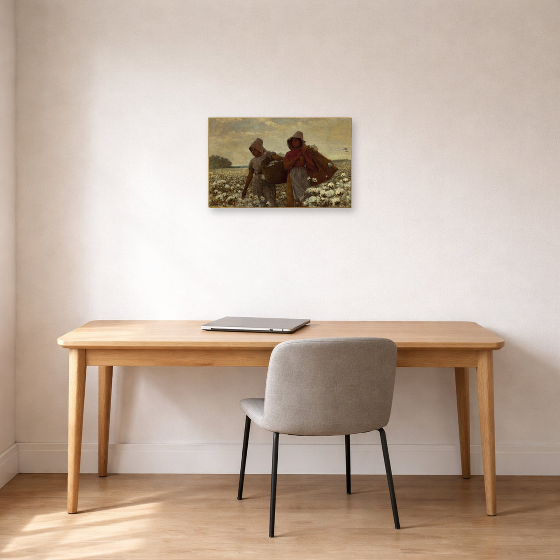 Unframed poster print of Winslow Homer's The Cotton Pickers displayed on a wall in an office